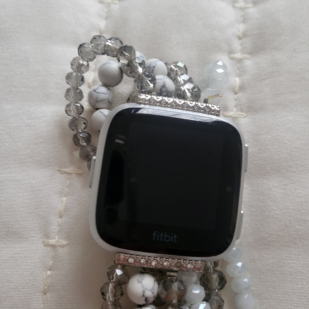 Fitbit Versa Smart Watch in Silver and Black.
